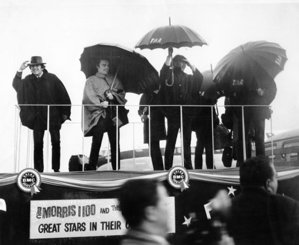 The Beatles arrive at Sydney airport in torrential rain on June 11, 1964. With them is stand-in drummer Jimmie Nicol. 